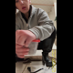 Miss Marilyn squats and holds a clear container of poop up to the camera, with more on the floor behind her. Presented in 720P vertical HD format. About half a minute.